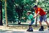 Dad and son learning to roller skate