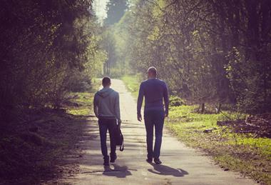 two men walking int he countryside