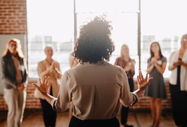 Woman giving an inspiring talk to colleagues