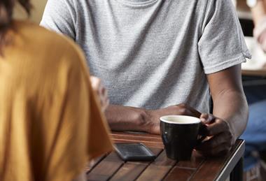 Two people sitting together having coffee