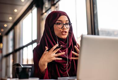 Woman in hijab partaking in an online meeting