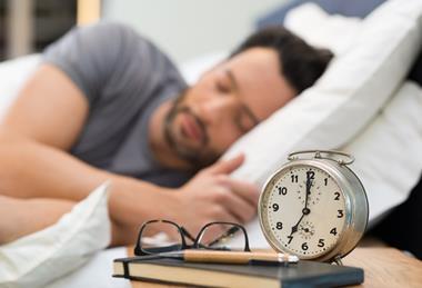 Man sleeping with alarm clock