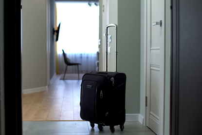 suitcase standing in an empty hallway