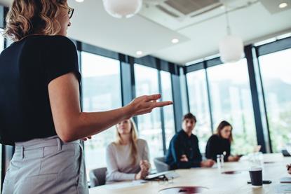 Lady delivering training to a room of students