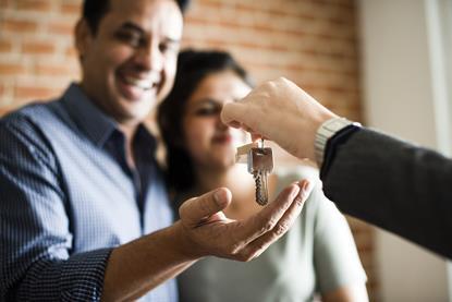 Couple receiving house keys to new property