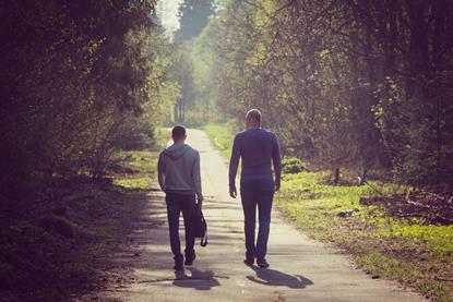 two men walking int he countryside