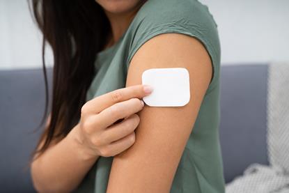 Woman putting a HRT patch on