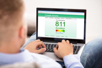 Man checking credit score on laptop badge