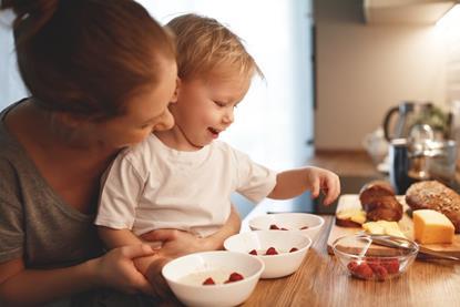 Mother preparing food with toddler