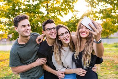 Group of teenagers taking a selfie and laughing