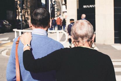 Older couple walking down a street together