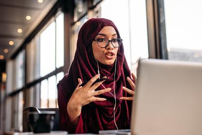 Woman in hijab partaking in an online meeting