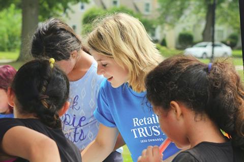 woman wearing Retail Trust T-shirt at an event